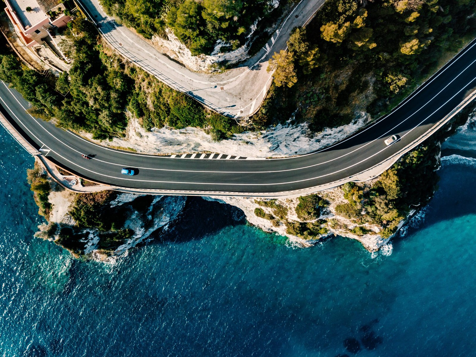 Aerial view of a coastal road symbolizing the long-term journey of retirement planning and financial strategy